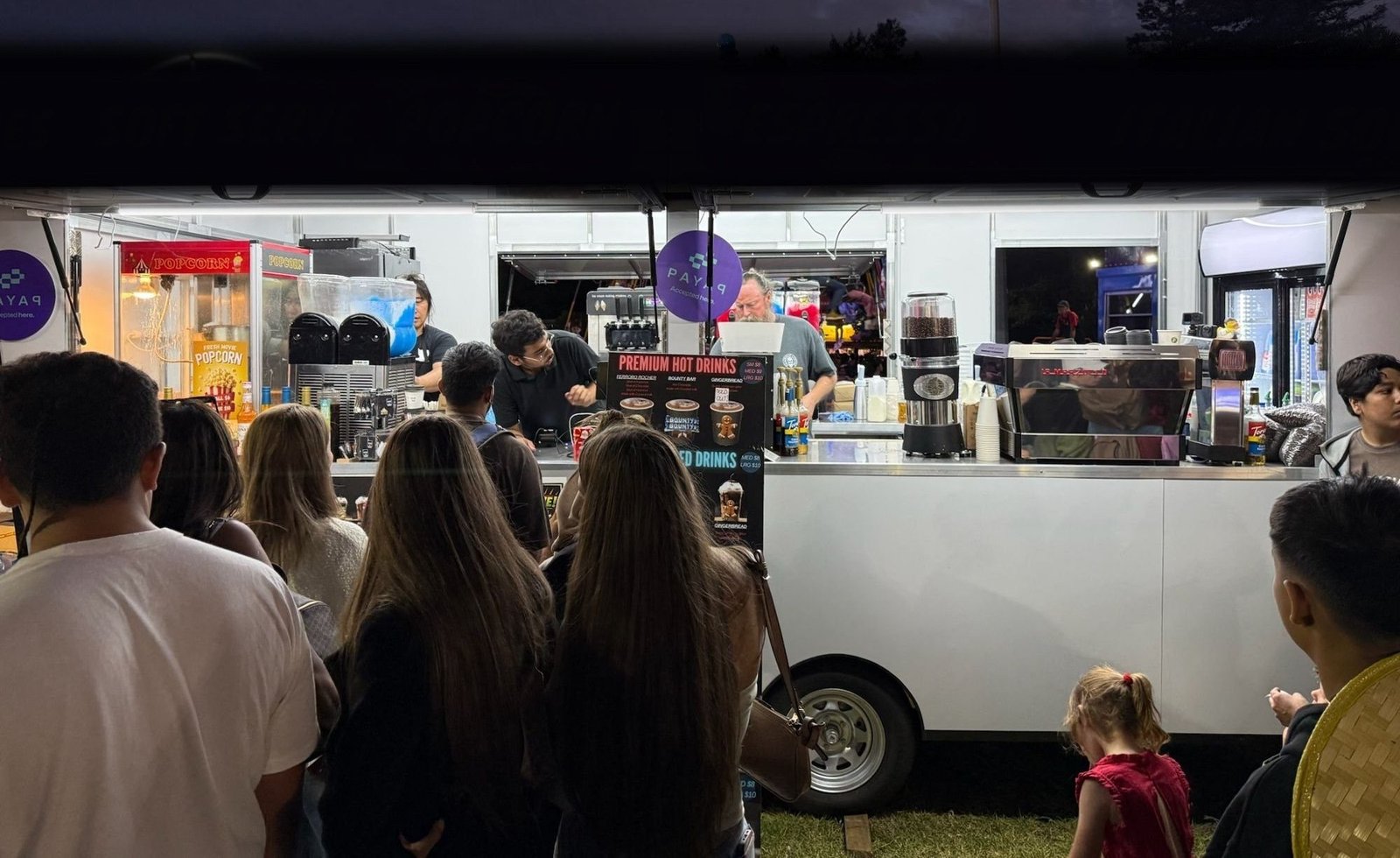 Headshot Coffee trailer serving a night-time festival crowd