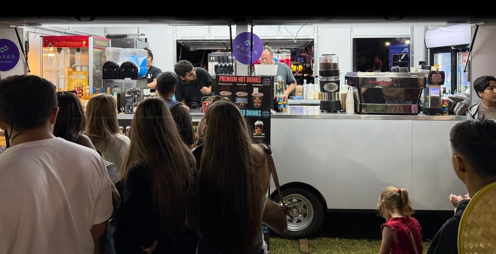 Headshot Coffee trailer serving a night-time festival crowd