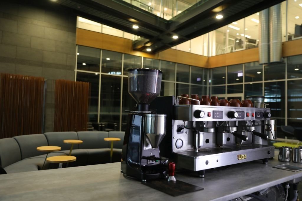 Commercial espresso machine and grinder on a workplace bench